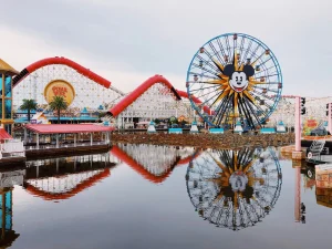 Bright amusement park featuring Mickey Mouse Ferris wheel and Disney-themed rides at Disney California Adventure.